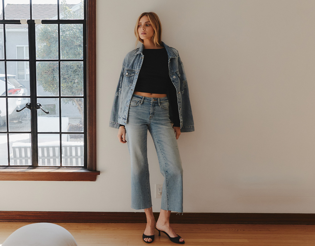 Model in High Rise Rhinestone Embellished Wide Leg Jeans and White Shirt with Black Vest and Blazer, linking to Flying Monkey best sellers collection.